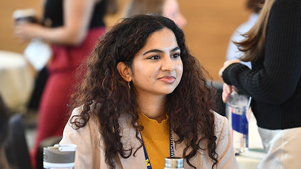 female student sitting at table wearing business wear